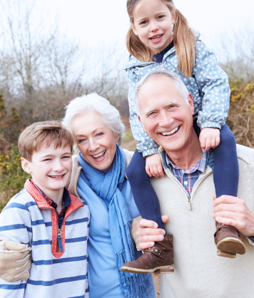 Person fitting a red orthopedic foot insole on another person's bare foot over a blue patterned surface.
