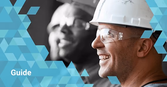 Two smiling construction workers wearing hard hats and safety glasses with blue geometric overlay and text 'Guide'.