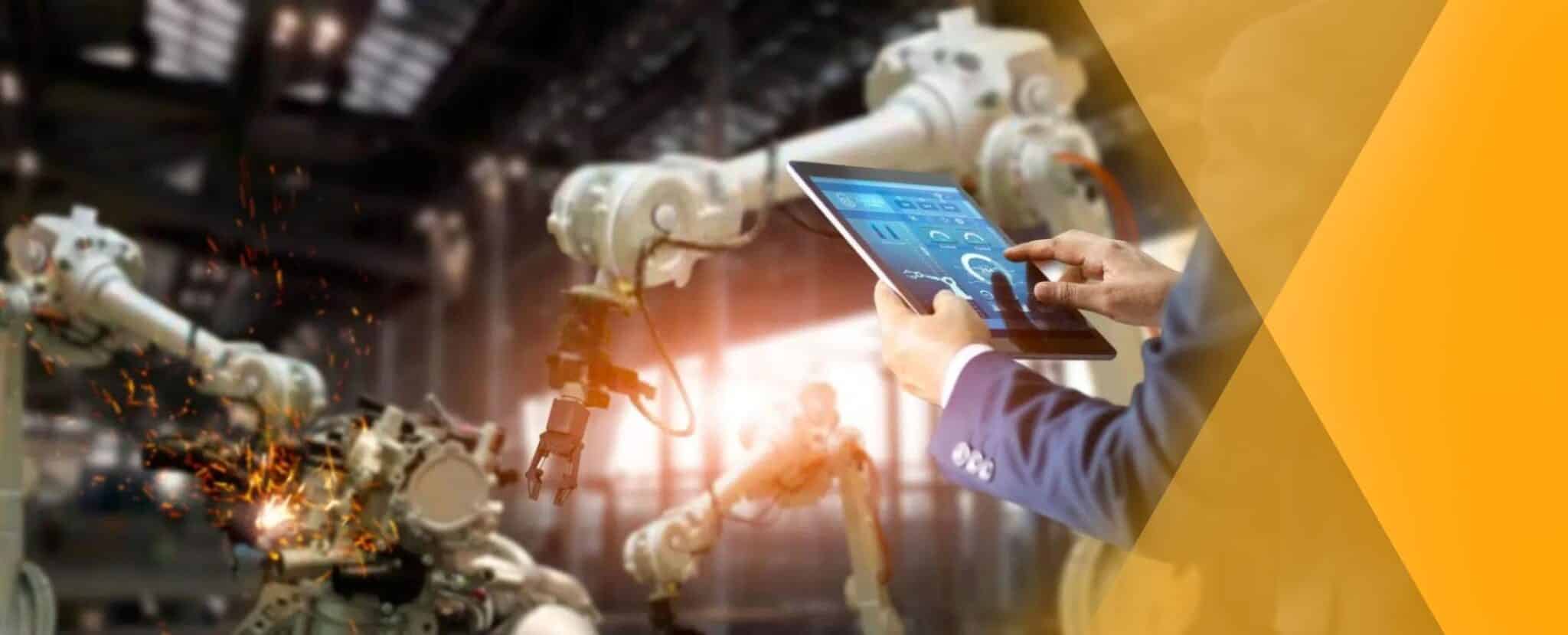 A person operates robotic arms in a factory using a touchscreen tablet, with sparks flying from one machine—showcasing the benefits of artificial intelligence in the workplace. Beekeeper