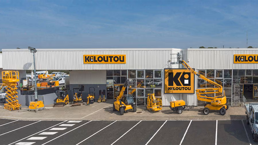 Kiloutou rental service building with various yellow construction machines and equipment outside.