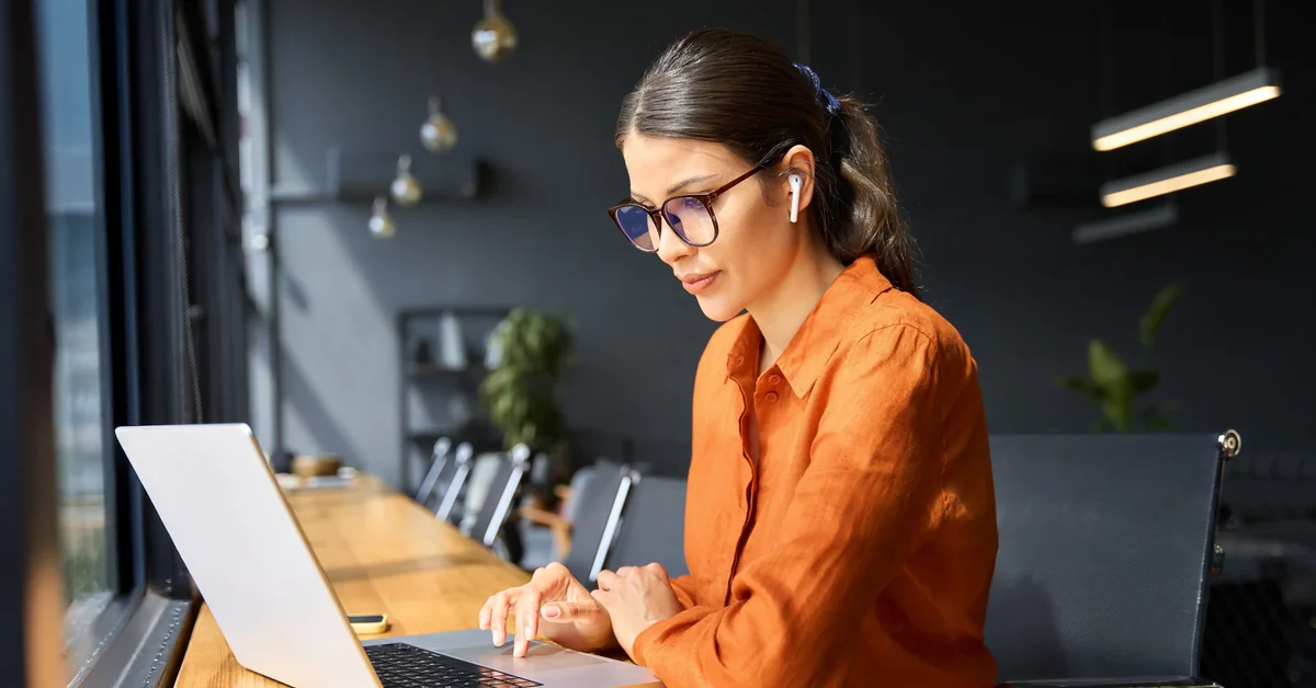 Employee working at a laptop in a modern office
