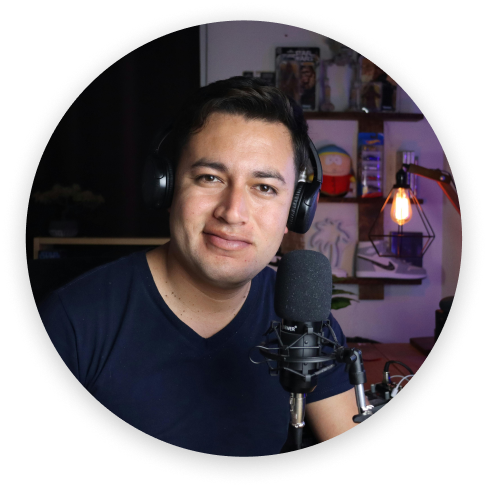 Man wearing headphones speaking into a microphone in a cozy room with shelves and a lit lamp in the background.