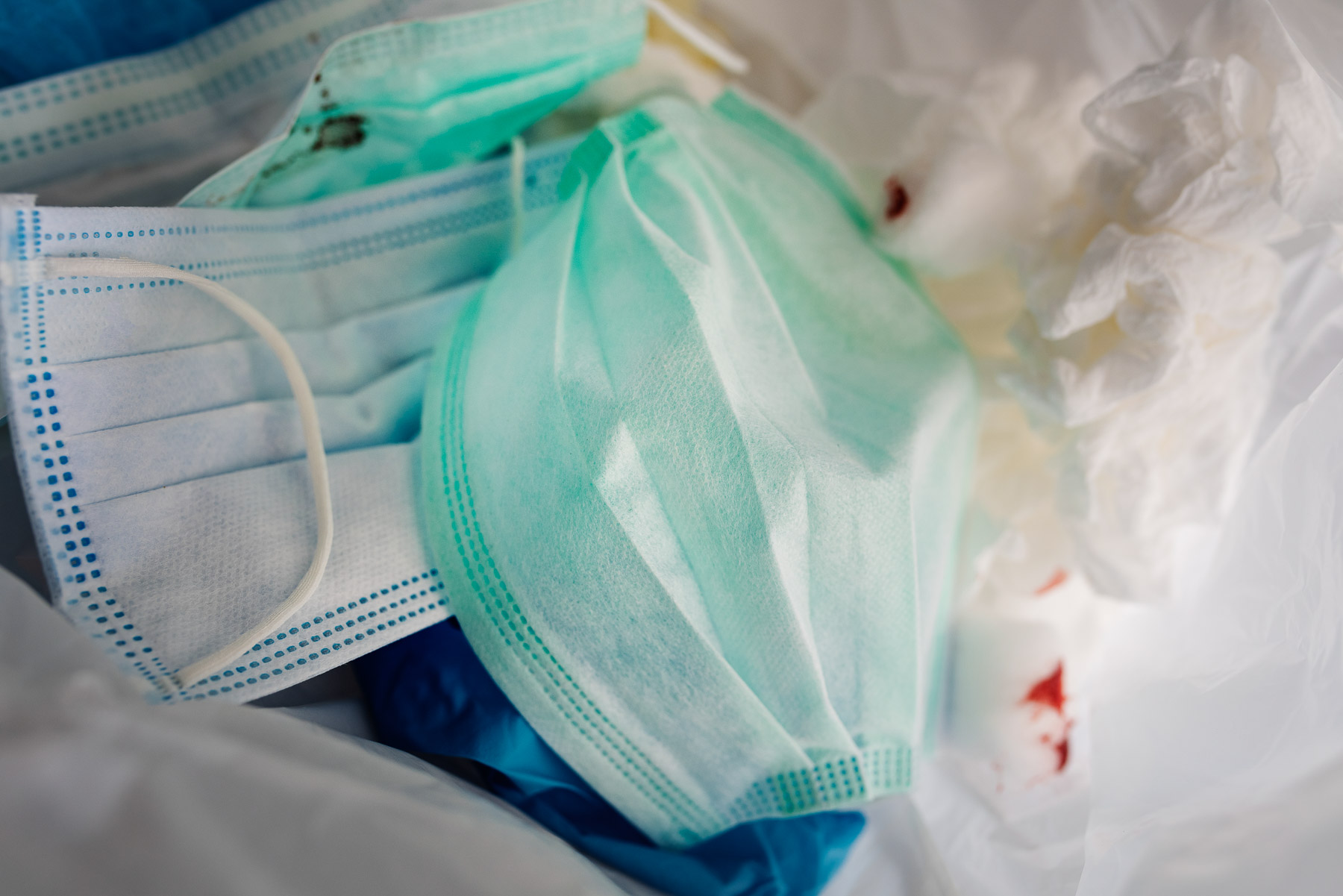 Disposable face masks in a lined clinical waste bin