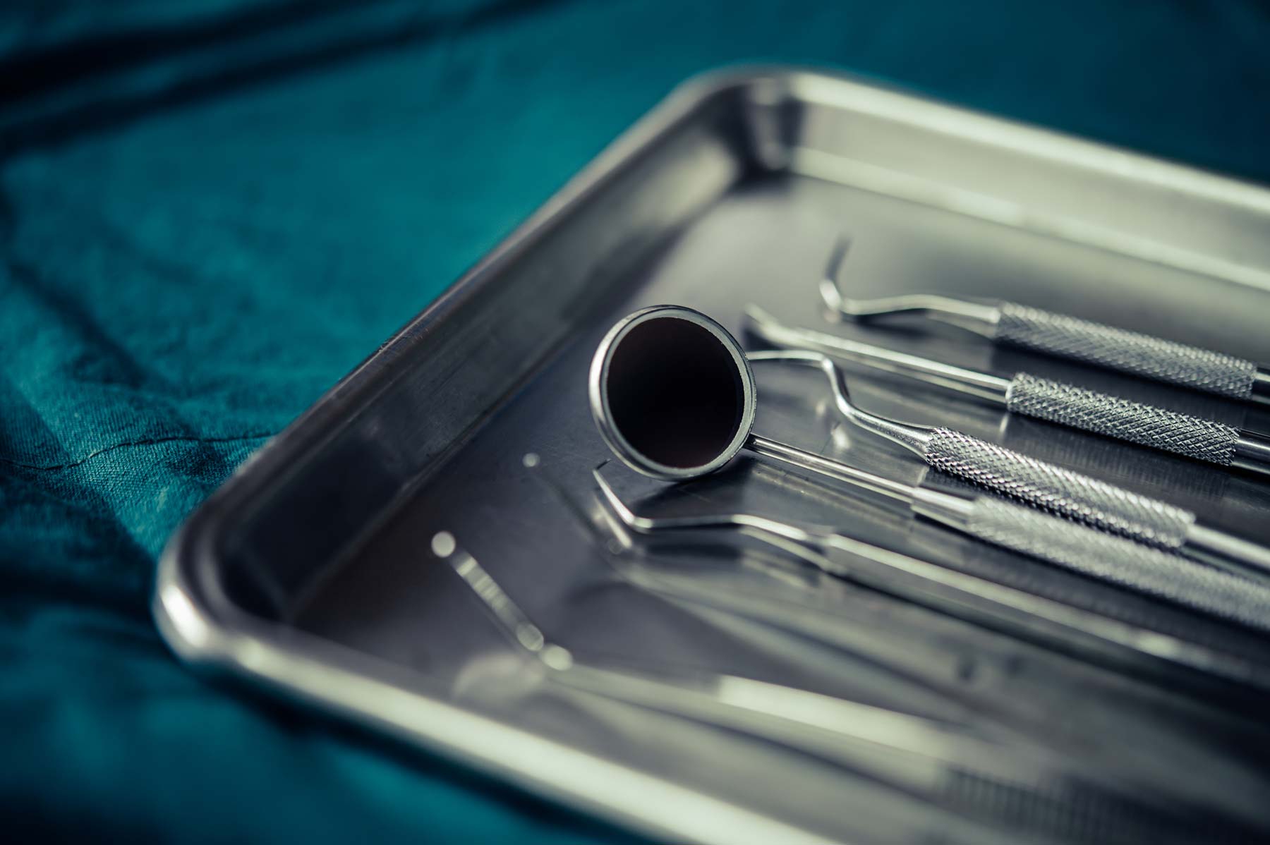 Dental instruments arranged on a metal treatment tray