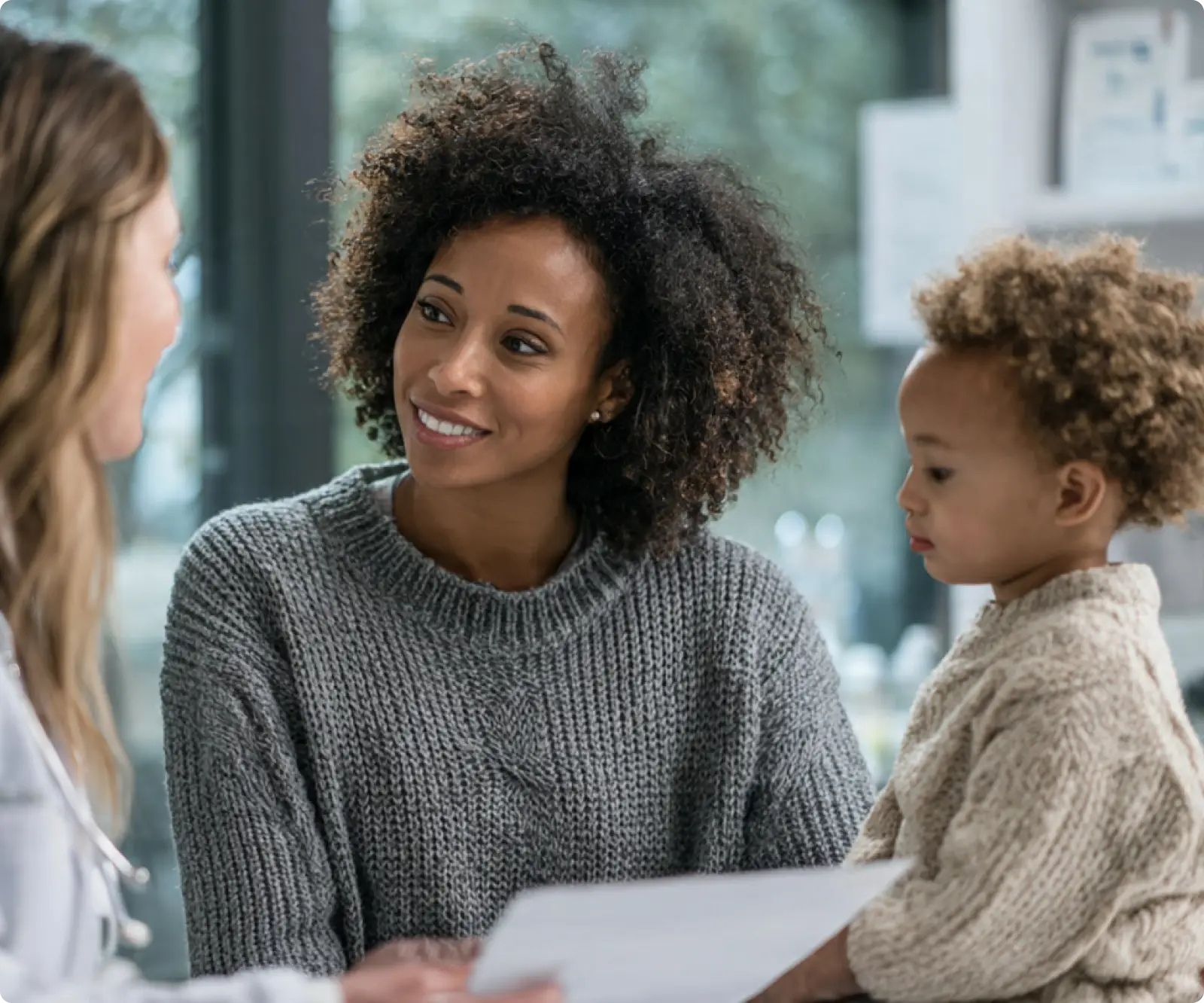 Two women and a child sitting at a table.