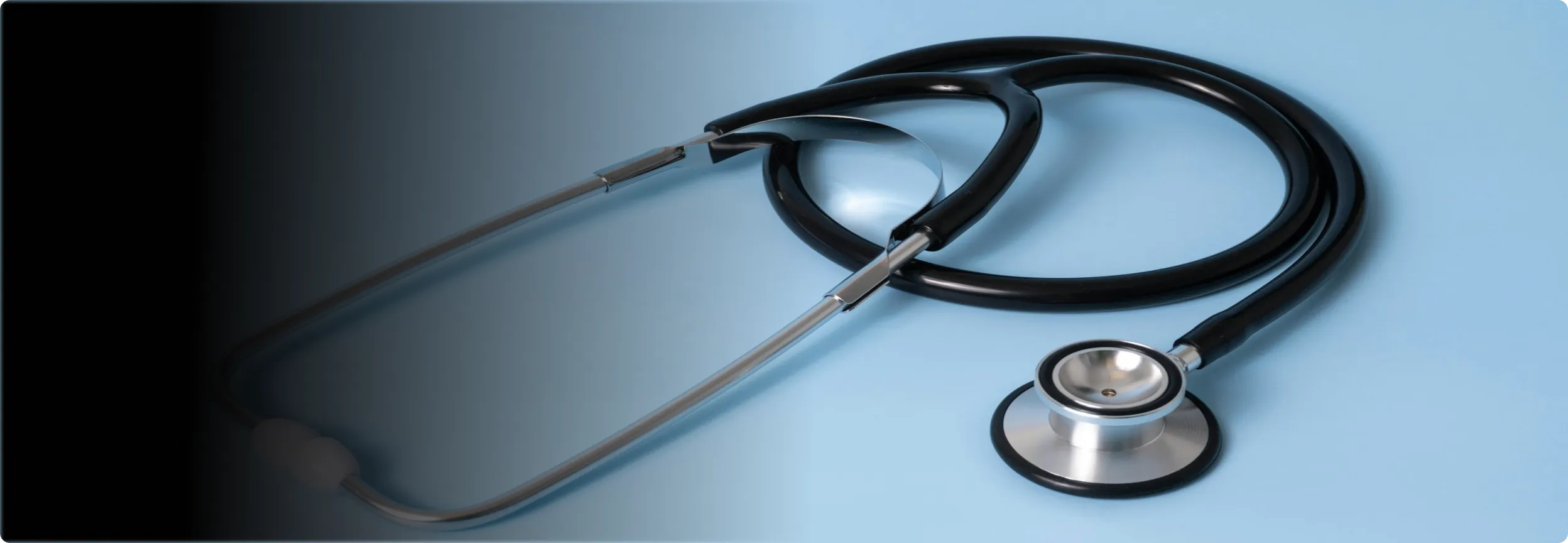 A nurse talking to an elderly man in a living room.