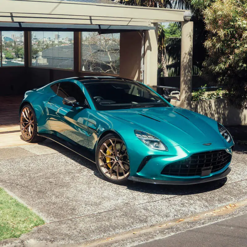 Luxury Aston Martin treated with a professional ceramic coating at a residential location