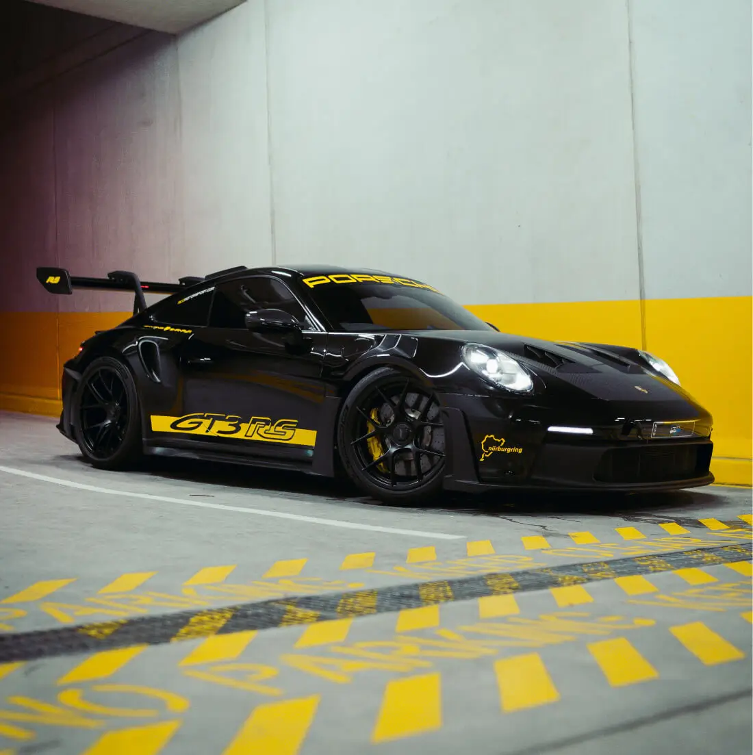 Front angle of a Porsche GT3 RS with paint protection film applied for impact resistance