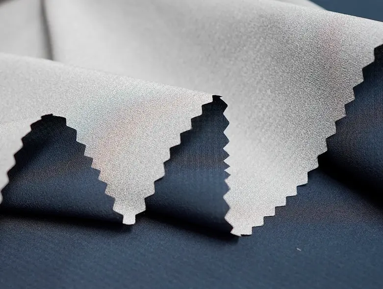 XReflex Stretch Wovens fabric, silver reflective face over a navy base