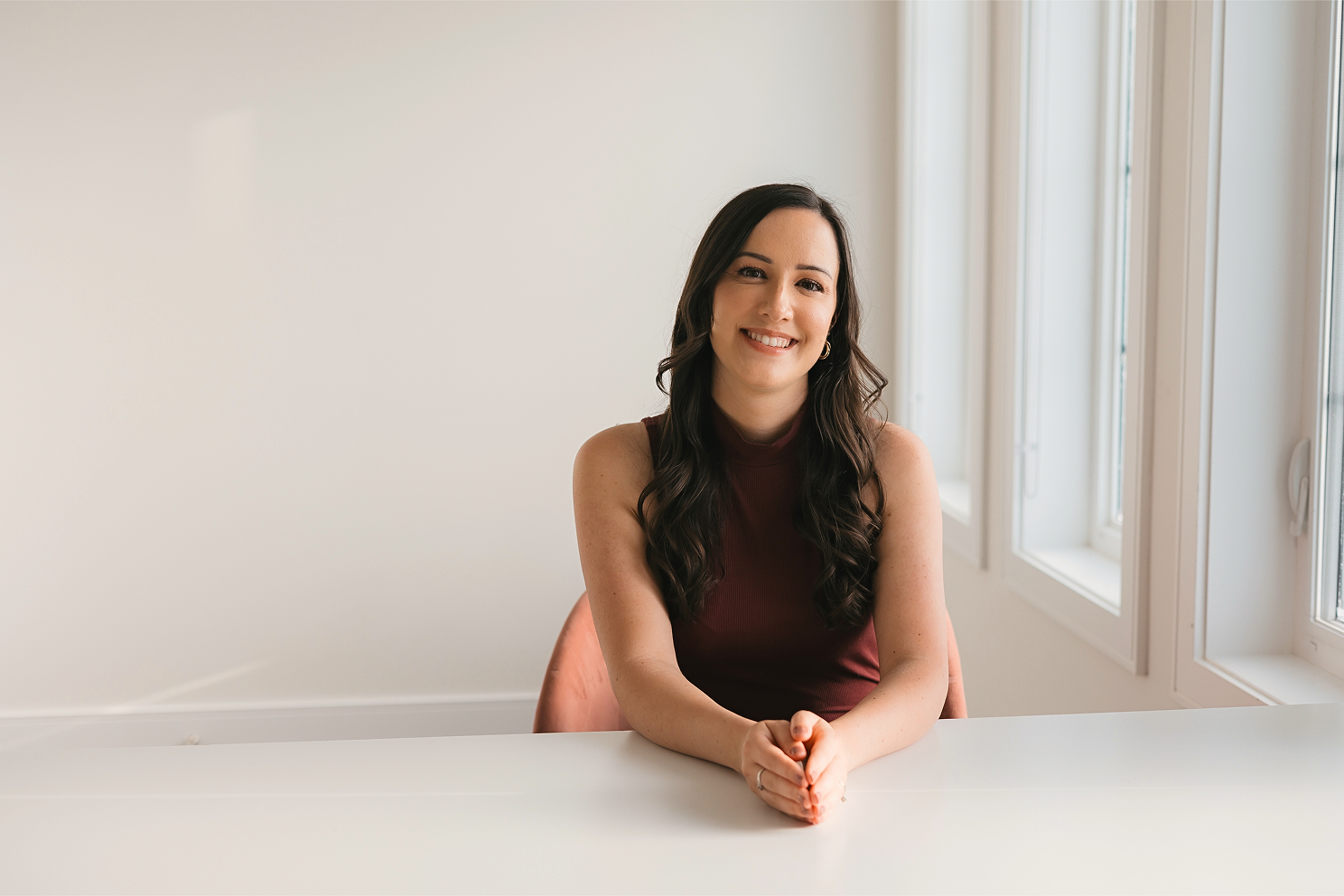 An image of Dr. Mckenzie sitting at the table in a white room