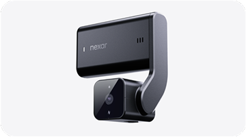 Compact black Nexar dash camera with a sleek, angular design on a light background.