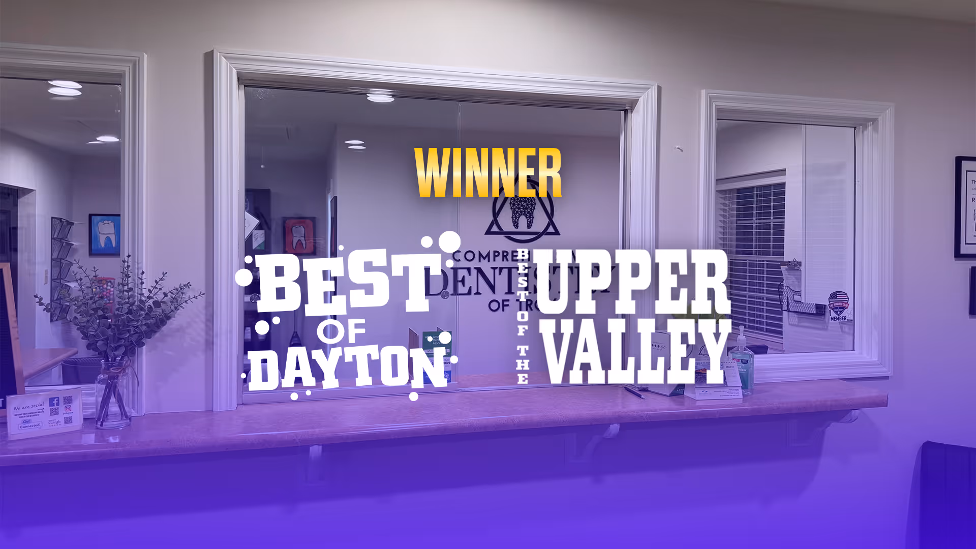 Dental office reception window with signage that reads 'Winner Best of Dayton Best of the Upper Valley'.