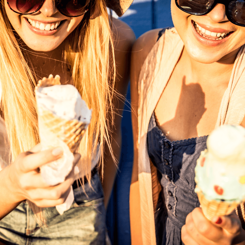 2 girls enjoying ice cream cones
