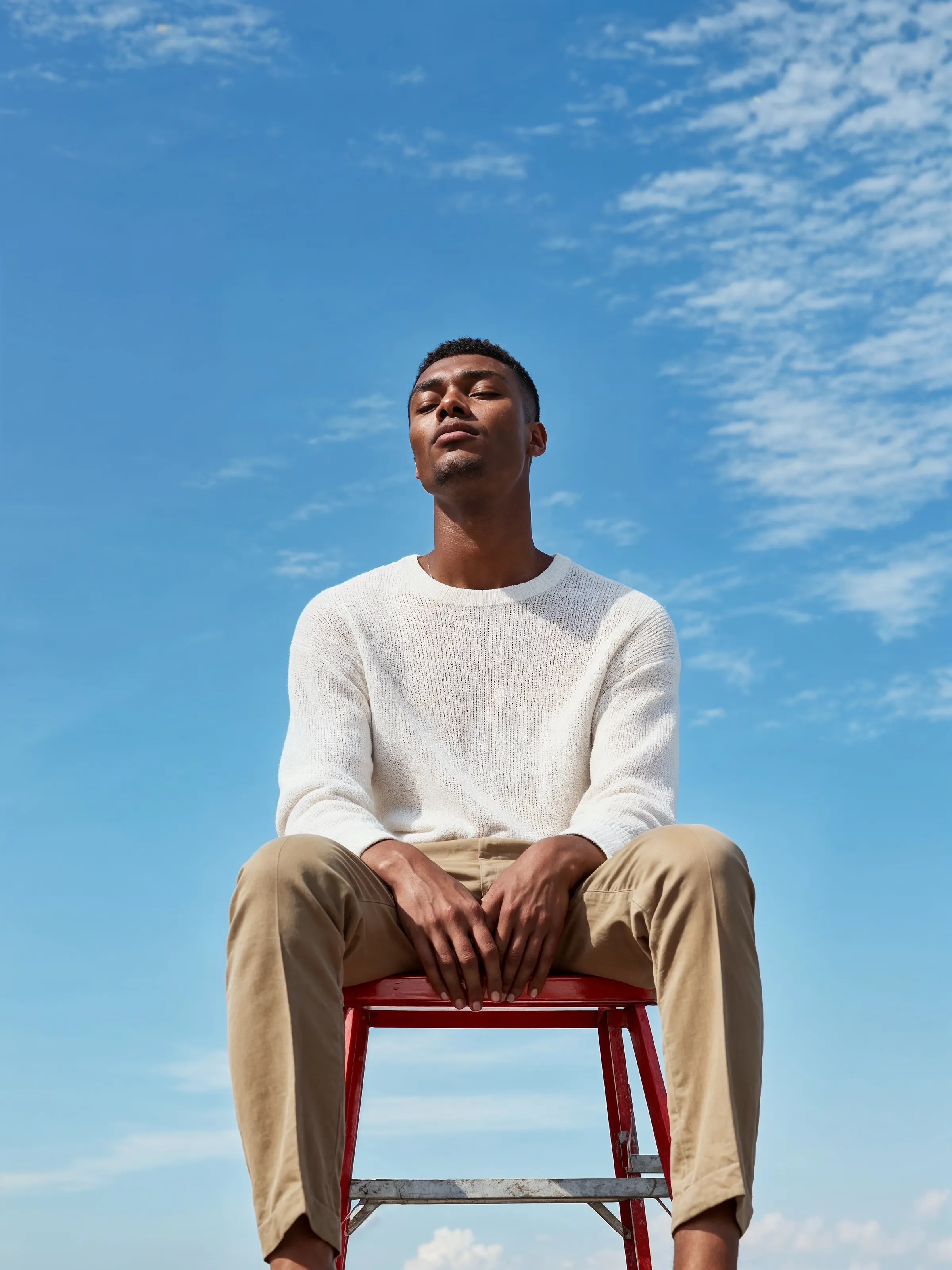 A man sitting on top of a red chair.