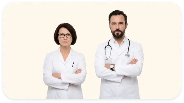 Two medical professionals wearing white lab coats standing with arms crossed against a plain background.