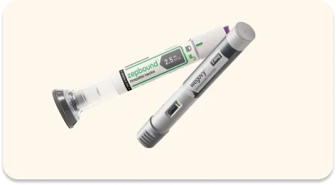 Two medical injection pens on a light background, one labeled Ozempic and the other labeled Wegovy.