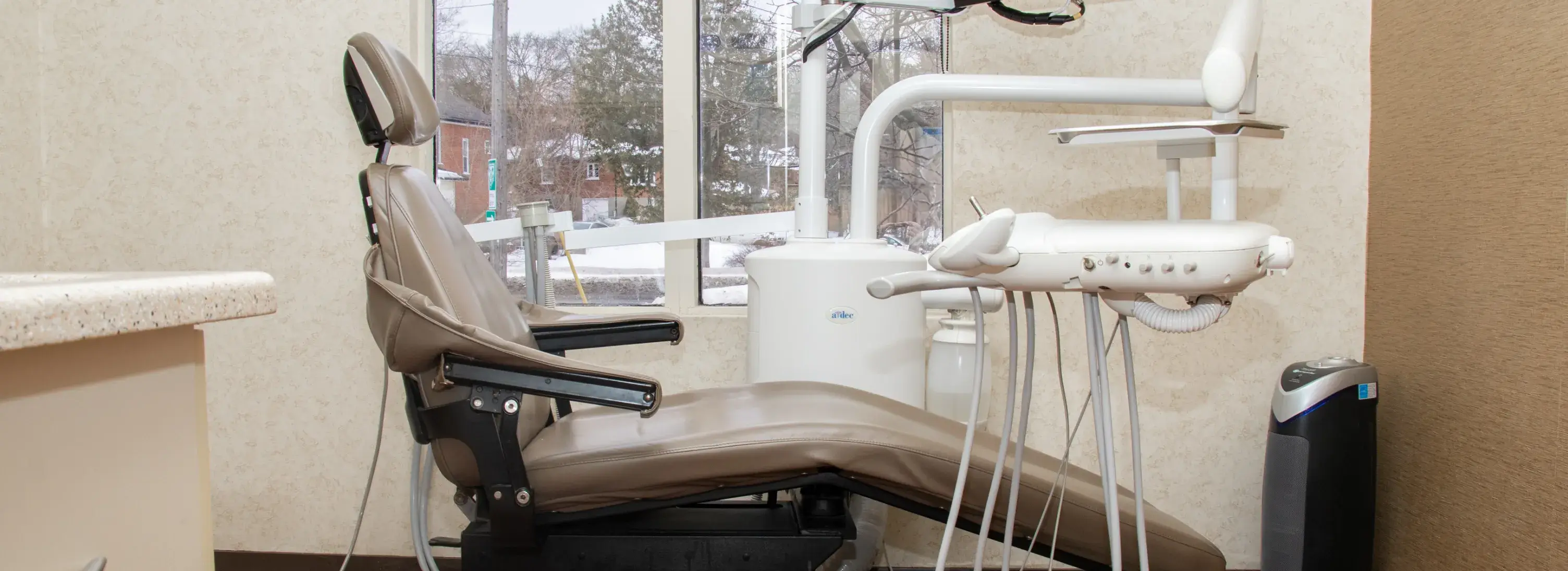 A dental professional explains a digital scan to a patient using a computer screen.
