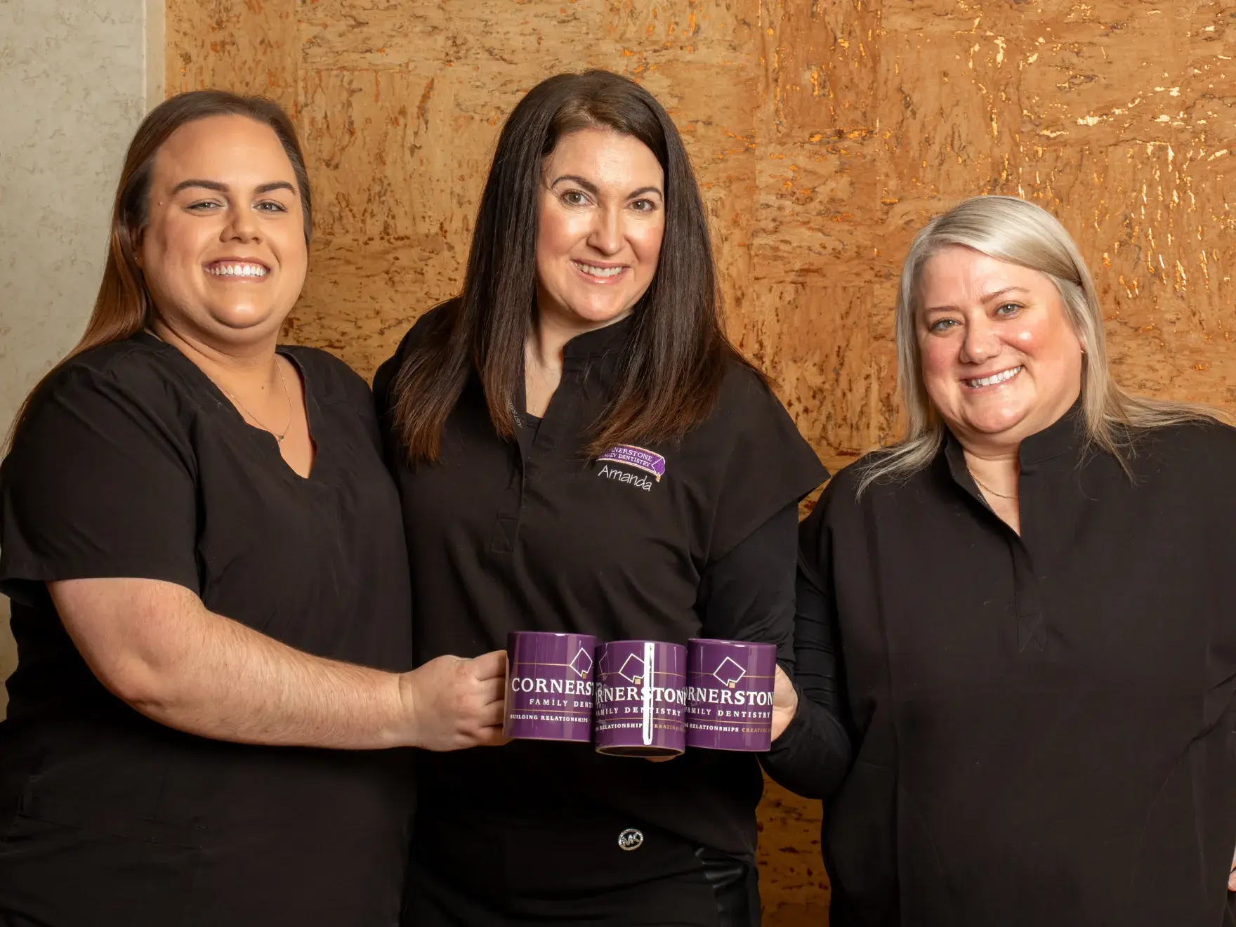 Dental office setup with a blue dentist chair, equipment, and white cabinets in a bright room.