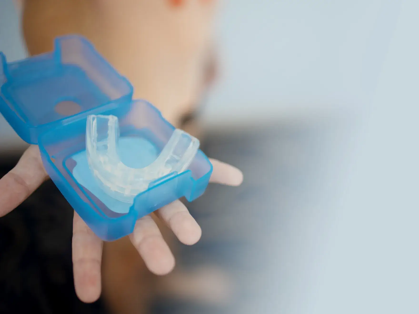 Two-story brick building with dark shutters and a purple sign reading "Cornerstone." Snow covers the ground.