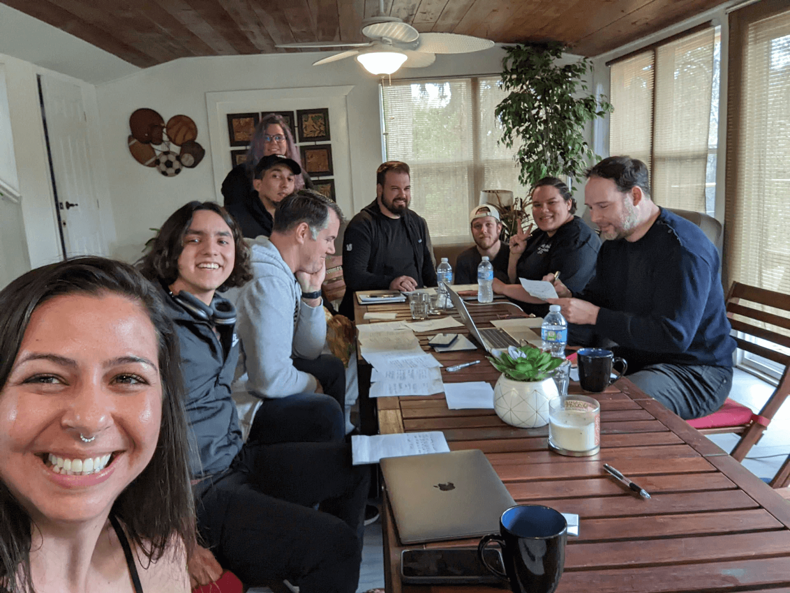 Yac employees gathering around a table for World Cafe