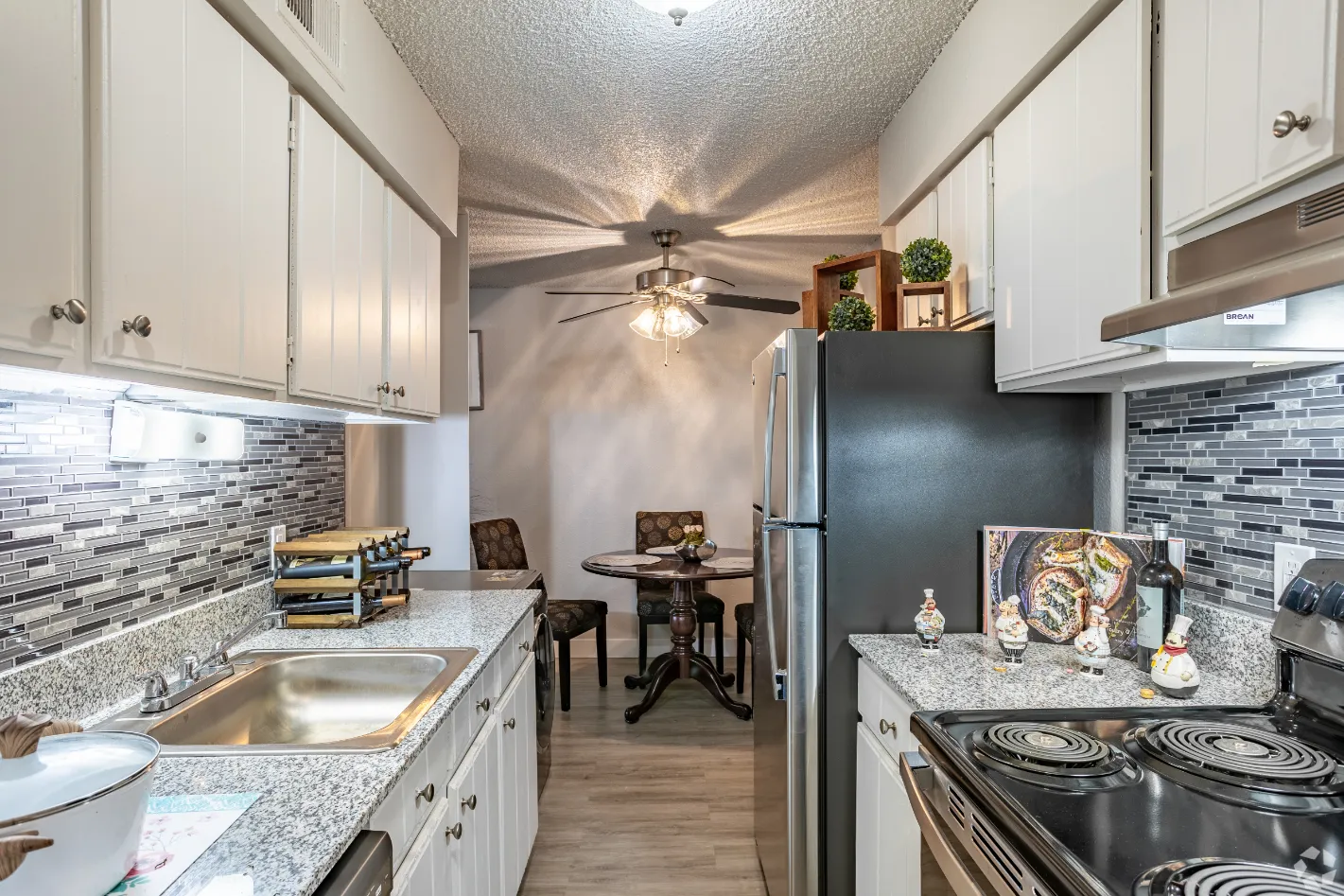 kitchen with stainless steel appliances and view of dining area with chairs