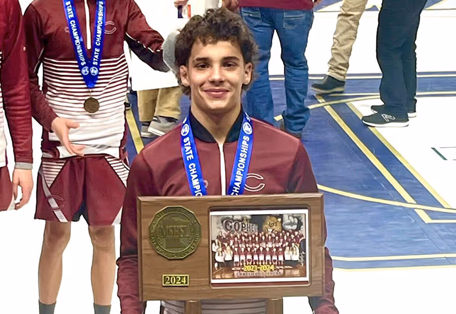 Youth athlete holding championship trophy after tournament win
