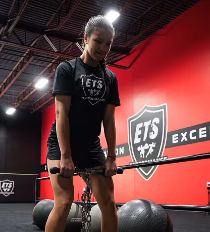 Athlete performing box jump during explosive training at ETS Performance