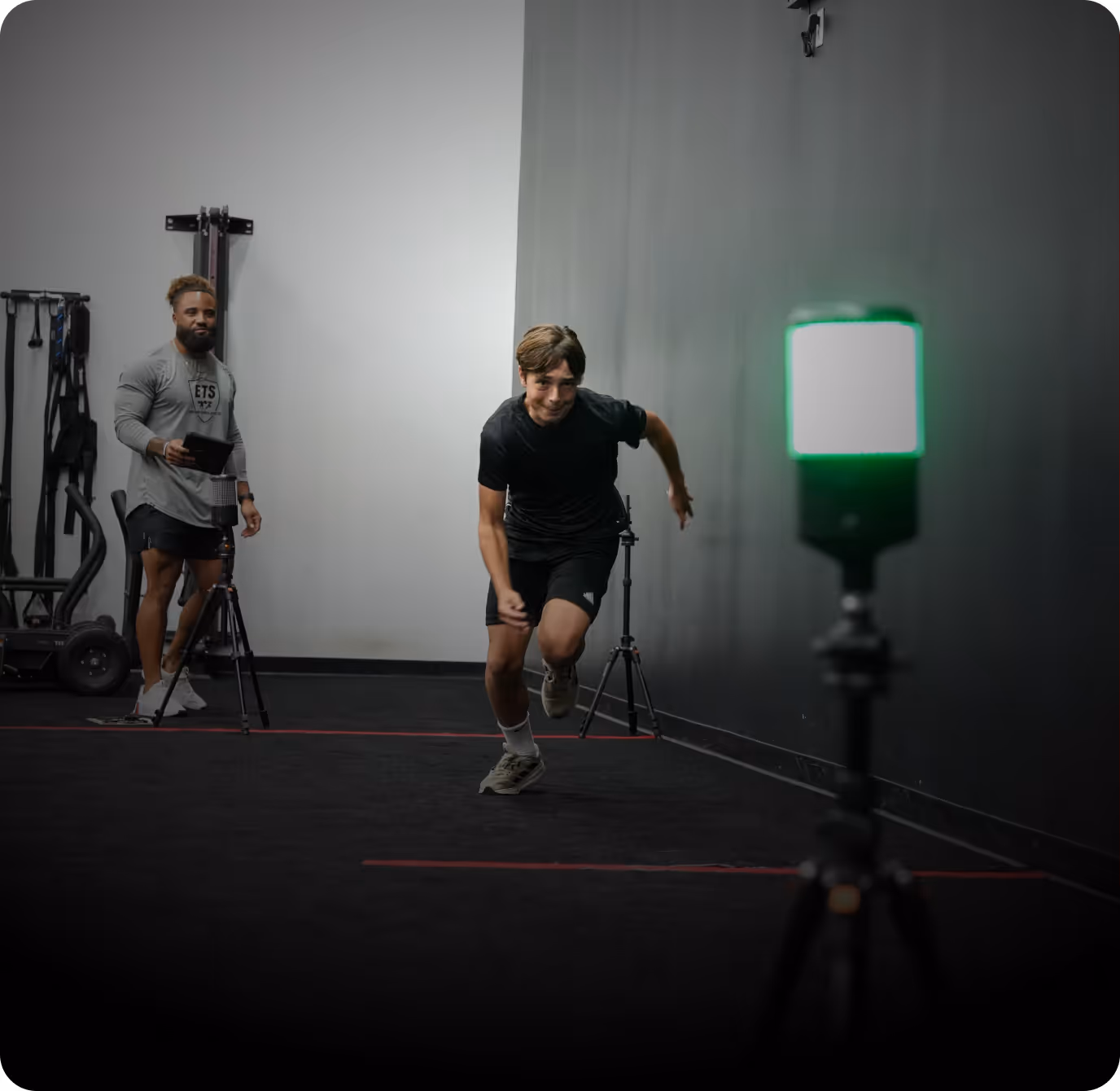 Athlete completing power training drill with coaching supervision