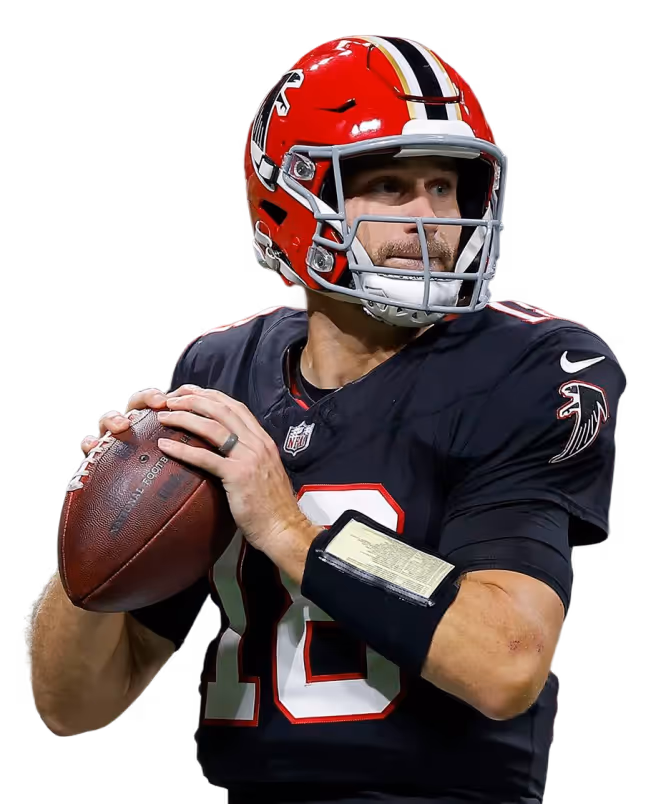 American football quarterback wearing a red helmet and black uniform preparing to throw a pass
