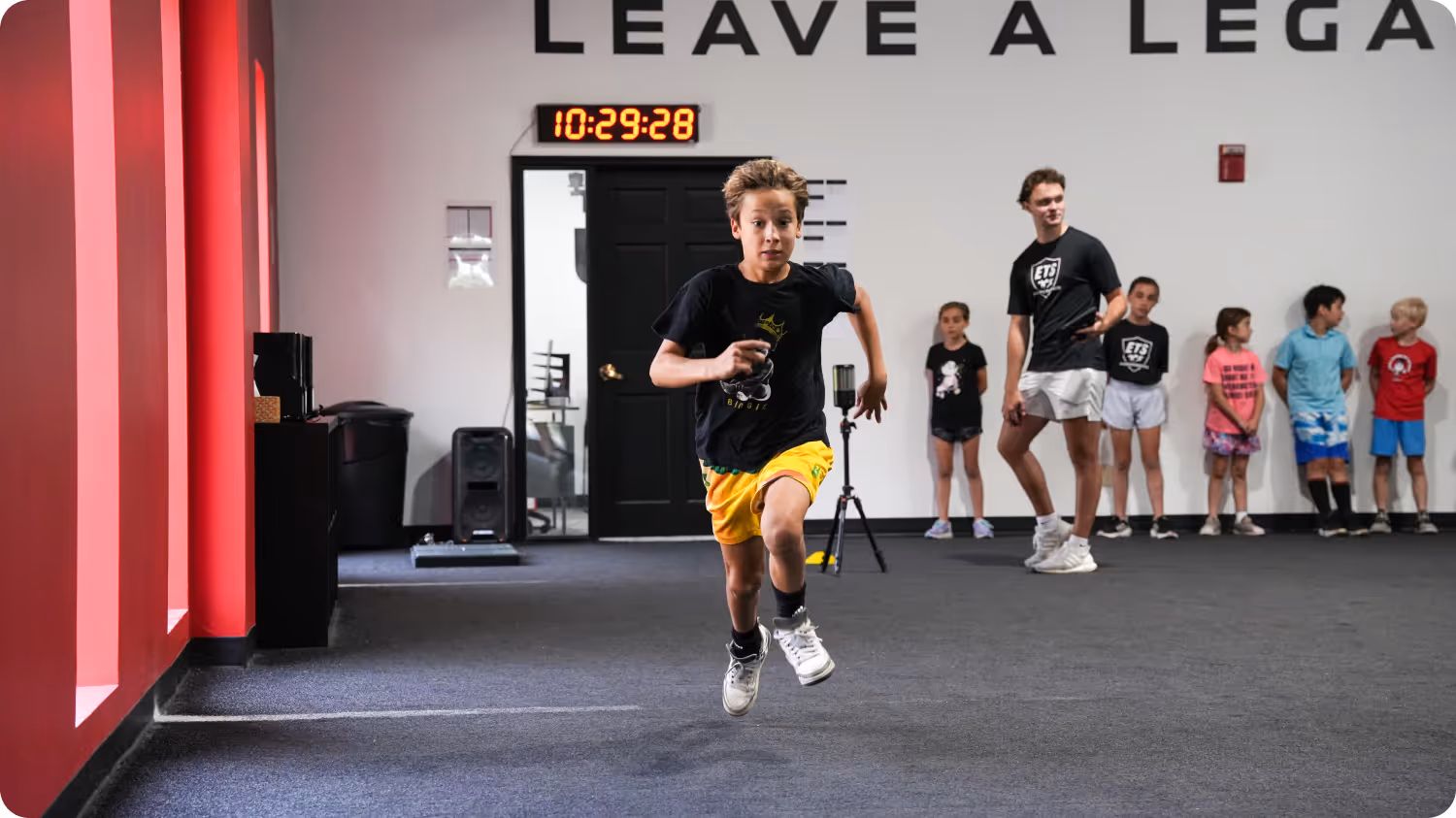 Athlete running inside training facility during performance workout