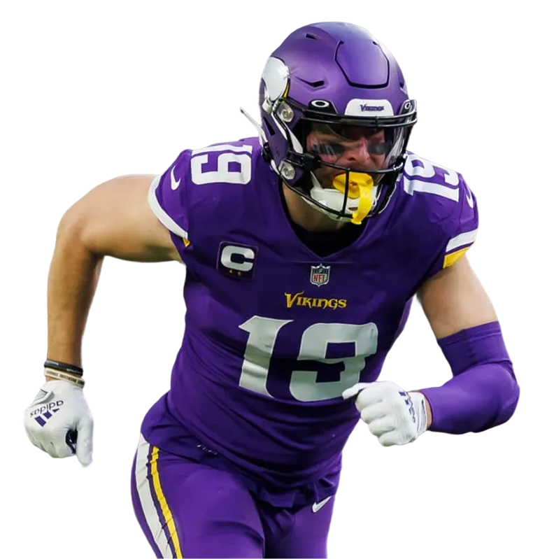 American football defensive player in green and white uniform raising one arm