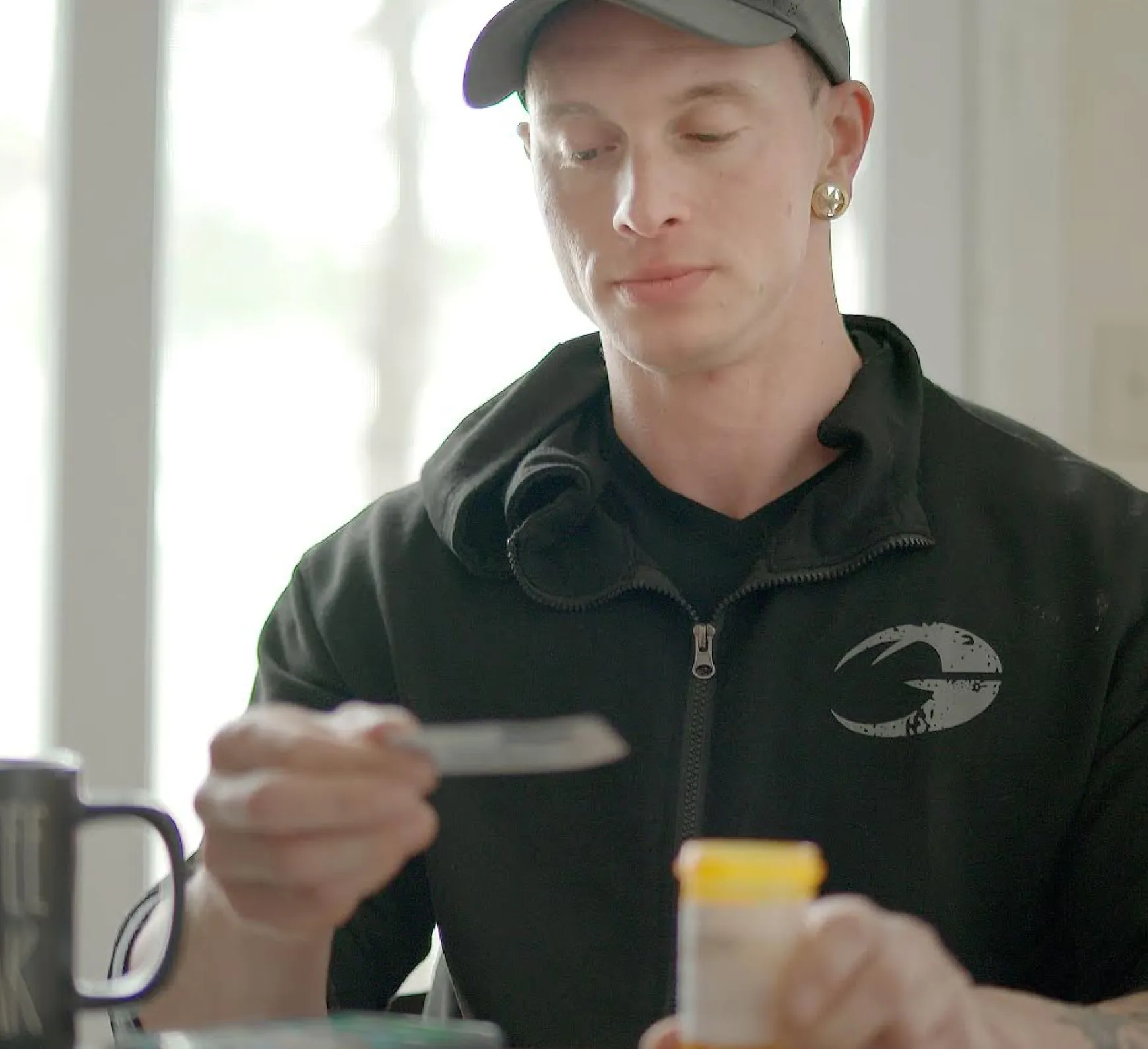 man reading instructions and holding pill container