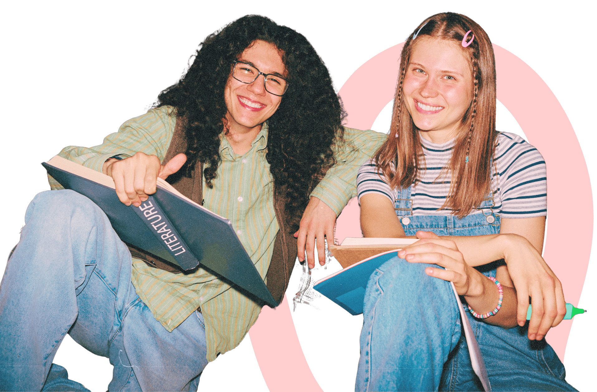 Two smiling students sitting casually with books