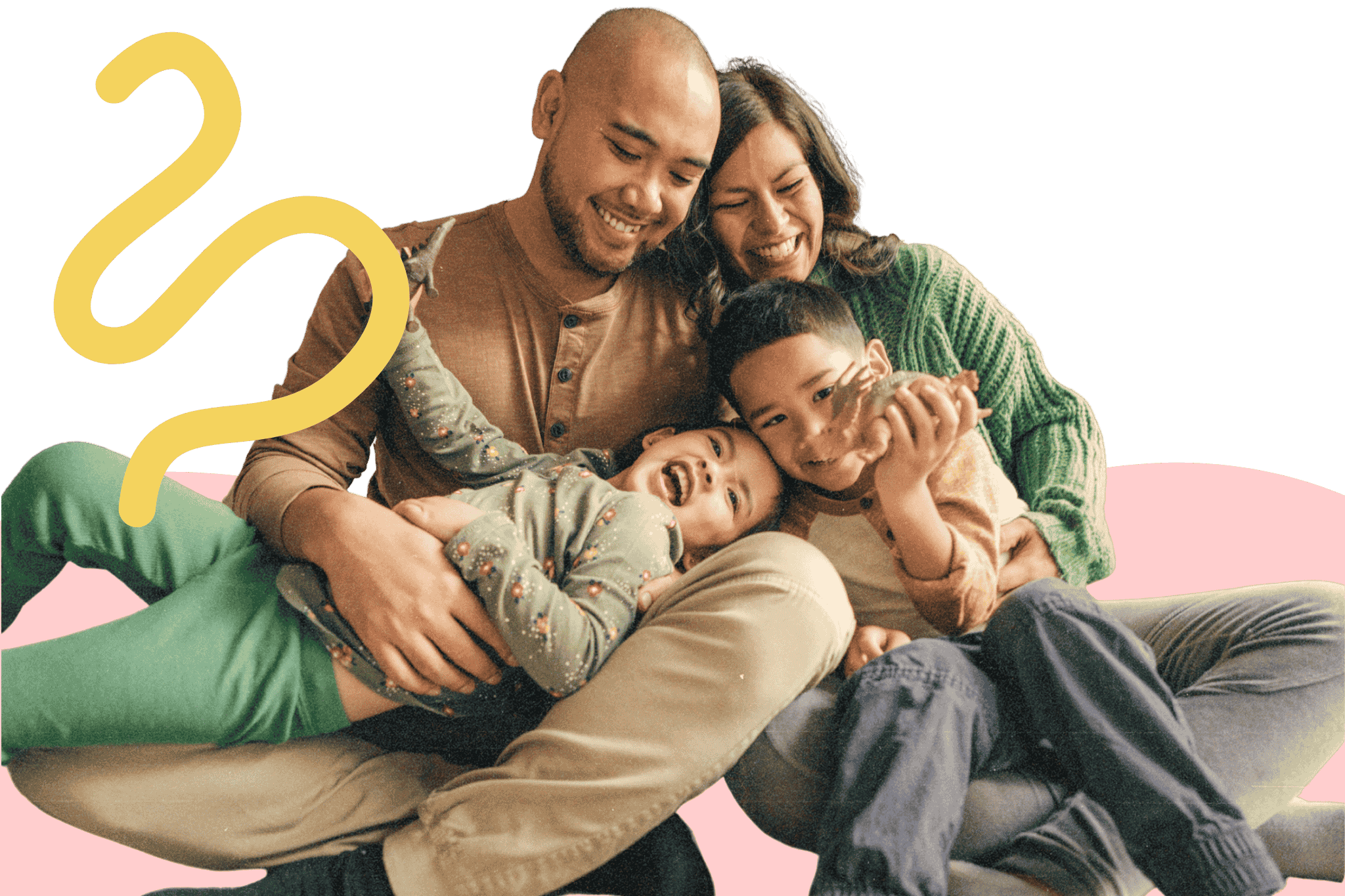Smiling family of four sitting closely together, with two children laughing and playing.