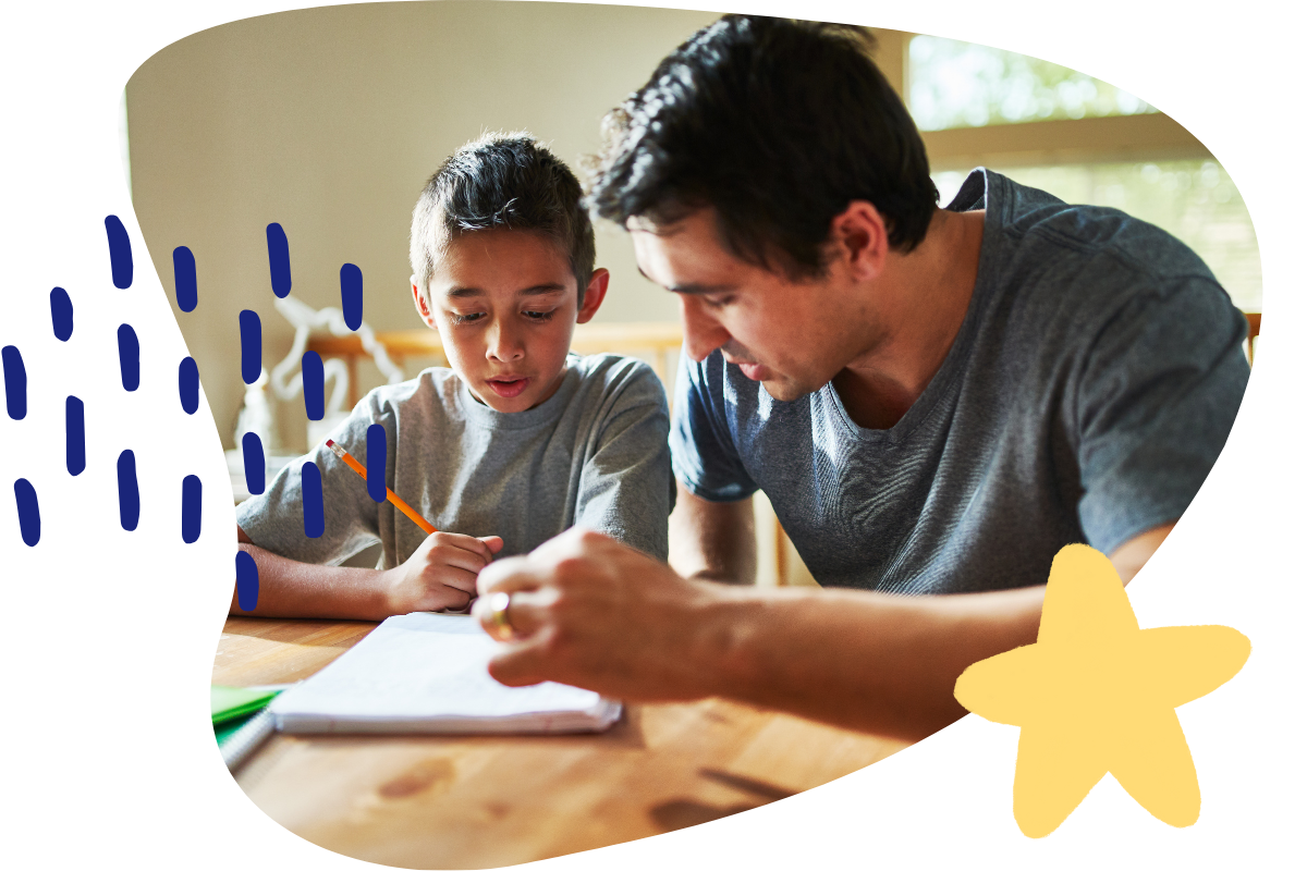father helping son with homework at a table