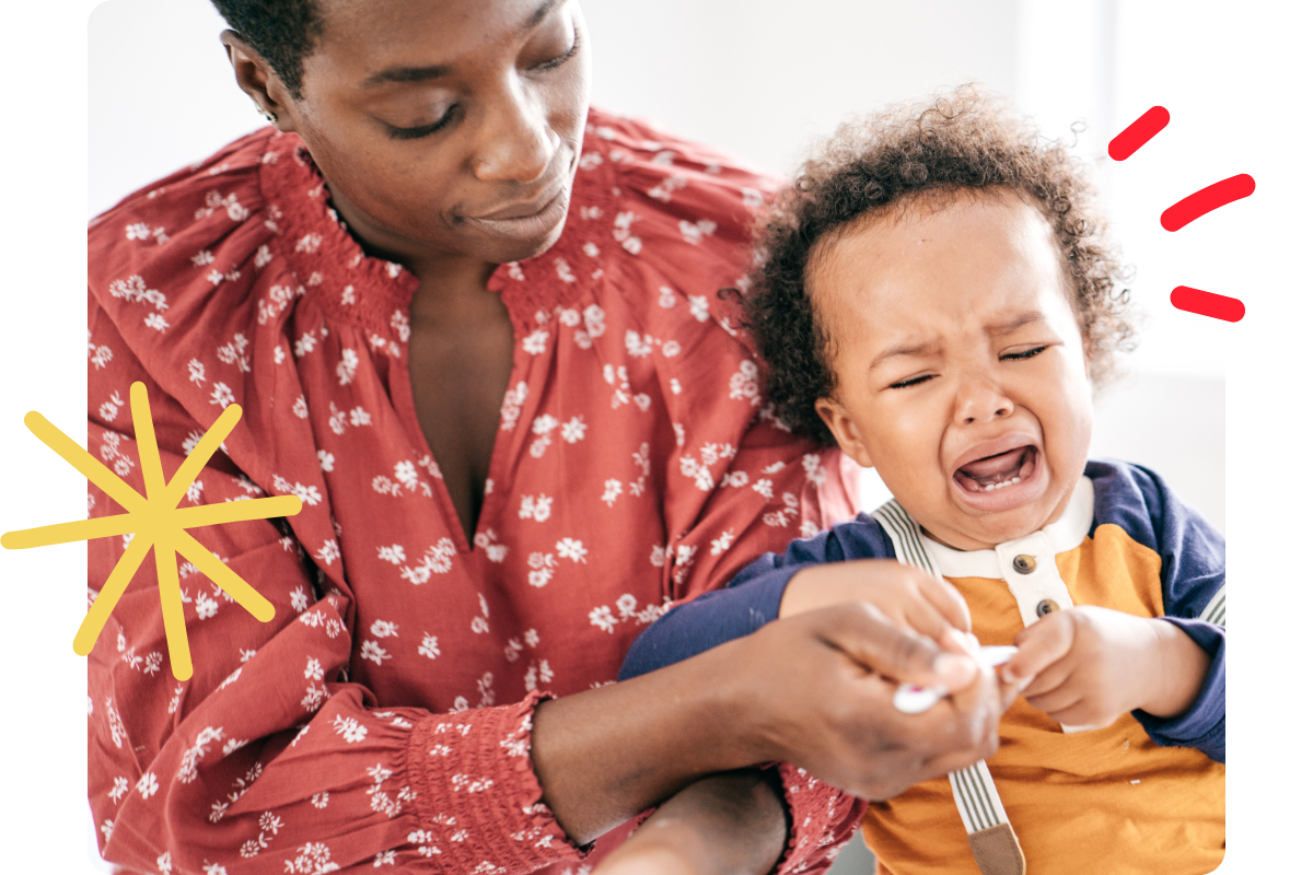 Parent trying to feed a toddler during a tantrum