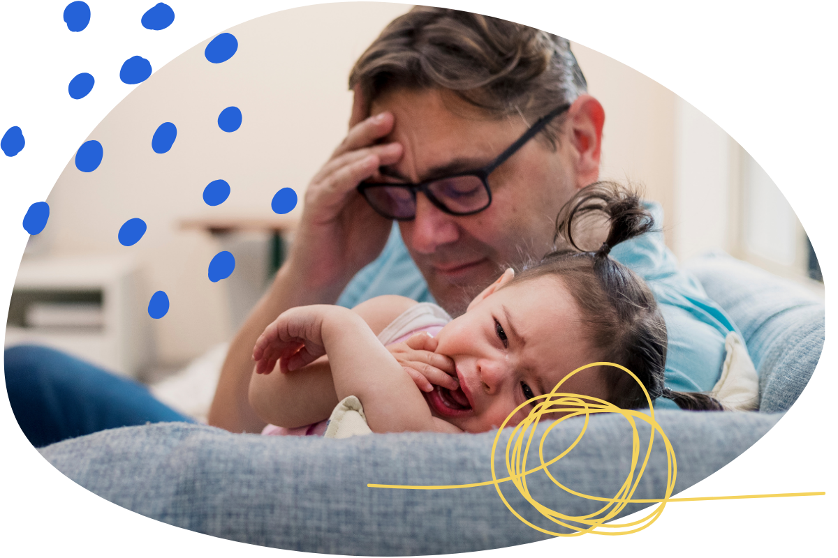 Parent holding a toddler throwing a tantrum