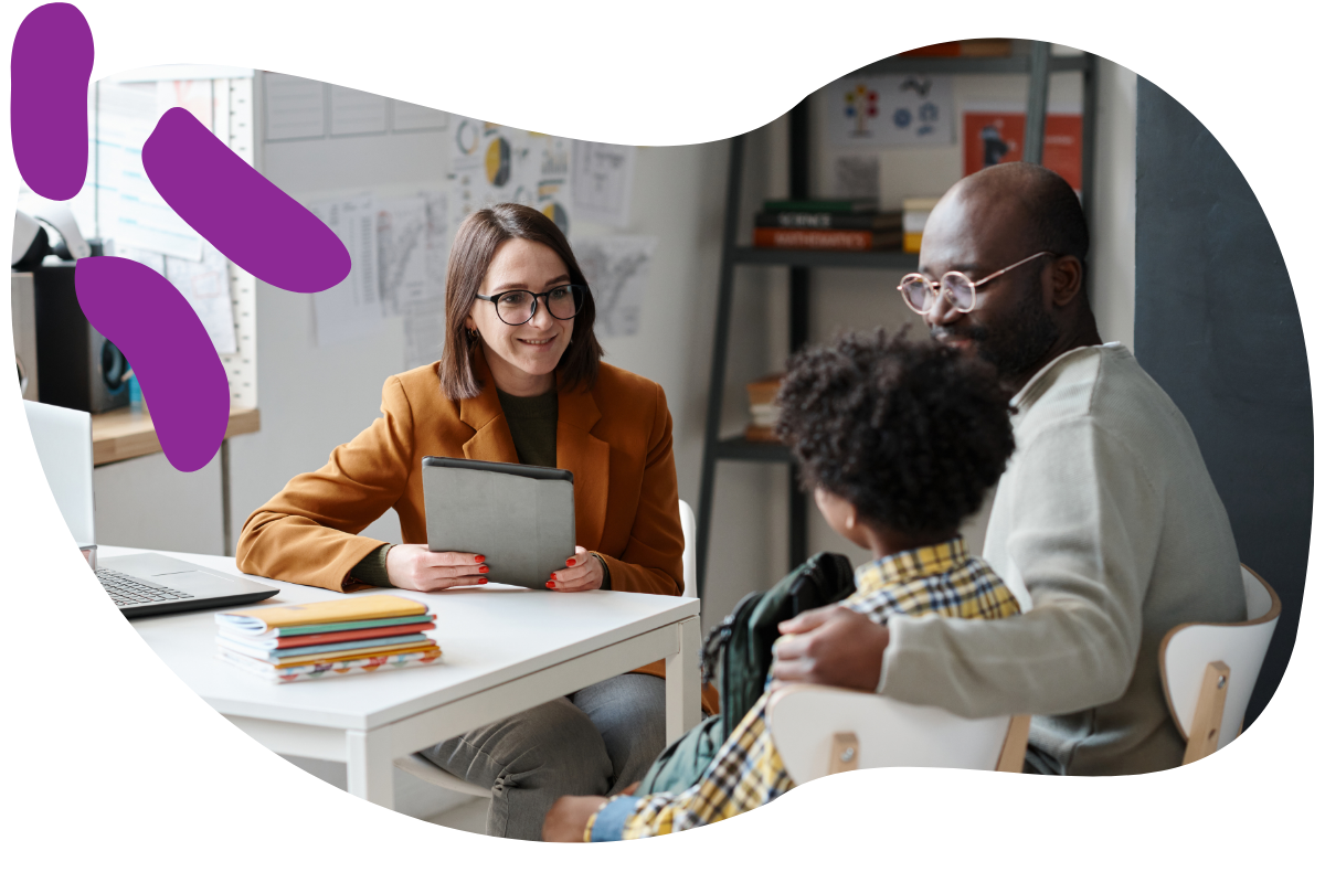 a teacher meeting with a father and child at school