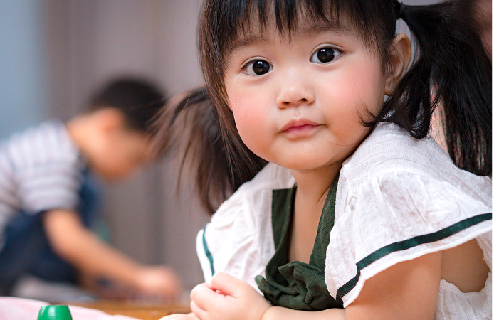 Toddler smiling at the camera