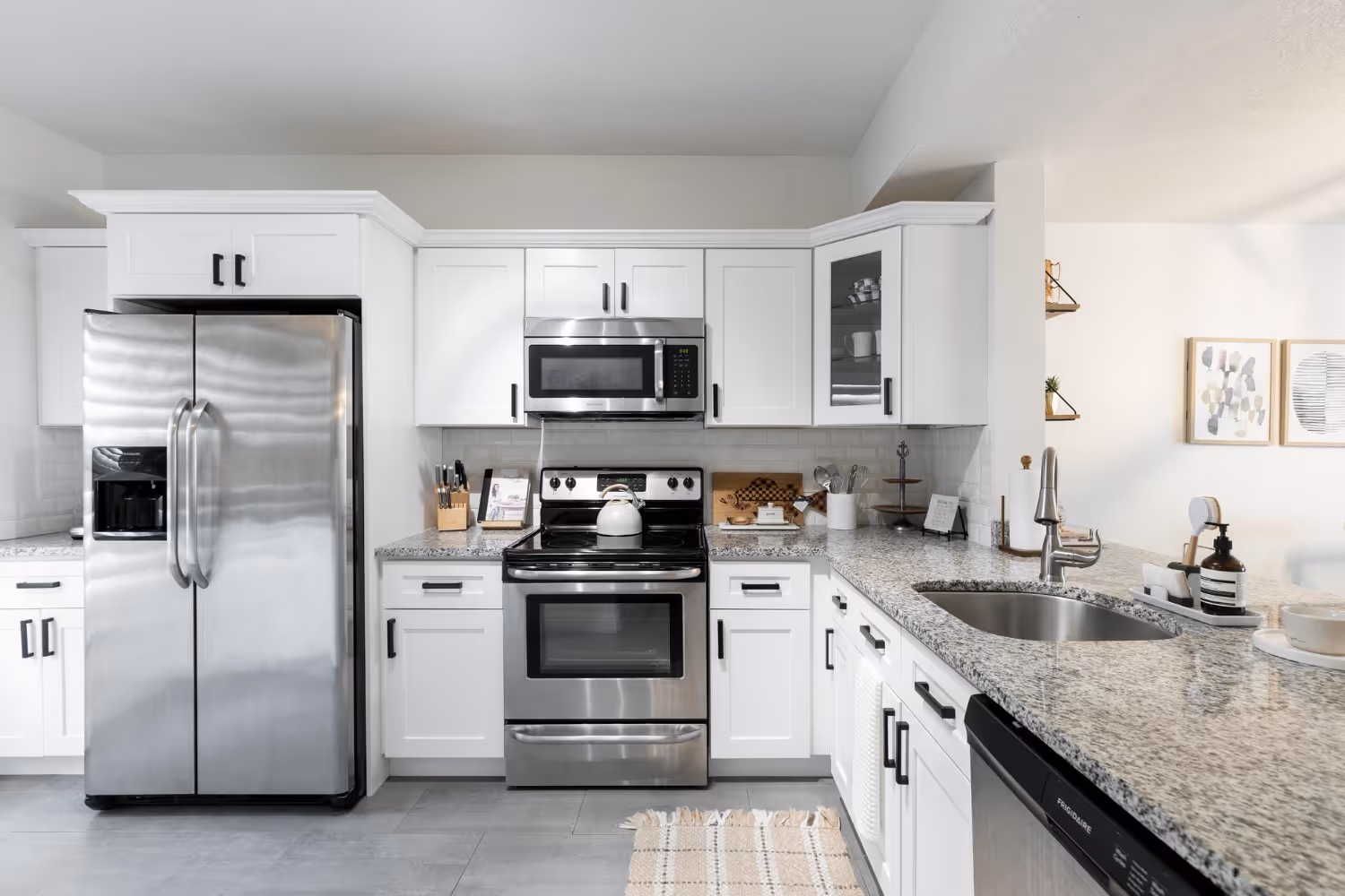Modern kitchen with stainless steel refrigerator, stove, and microwave