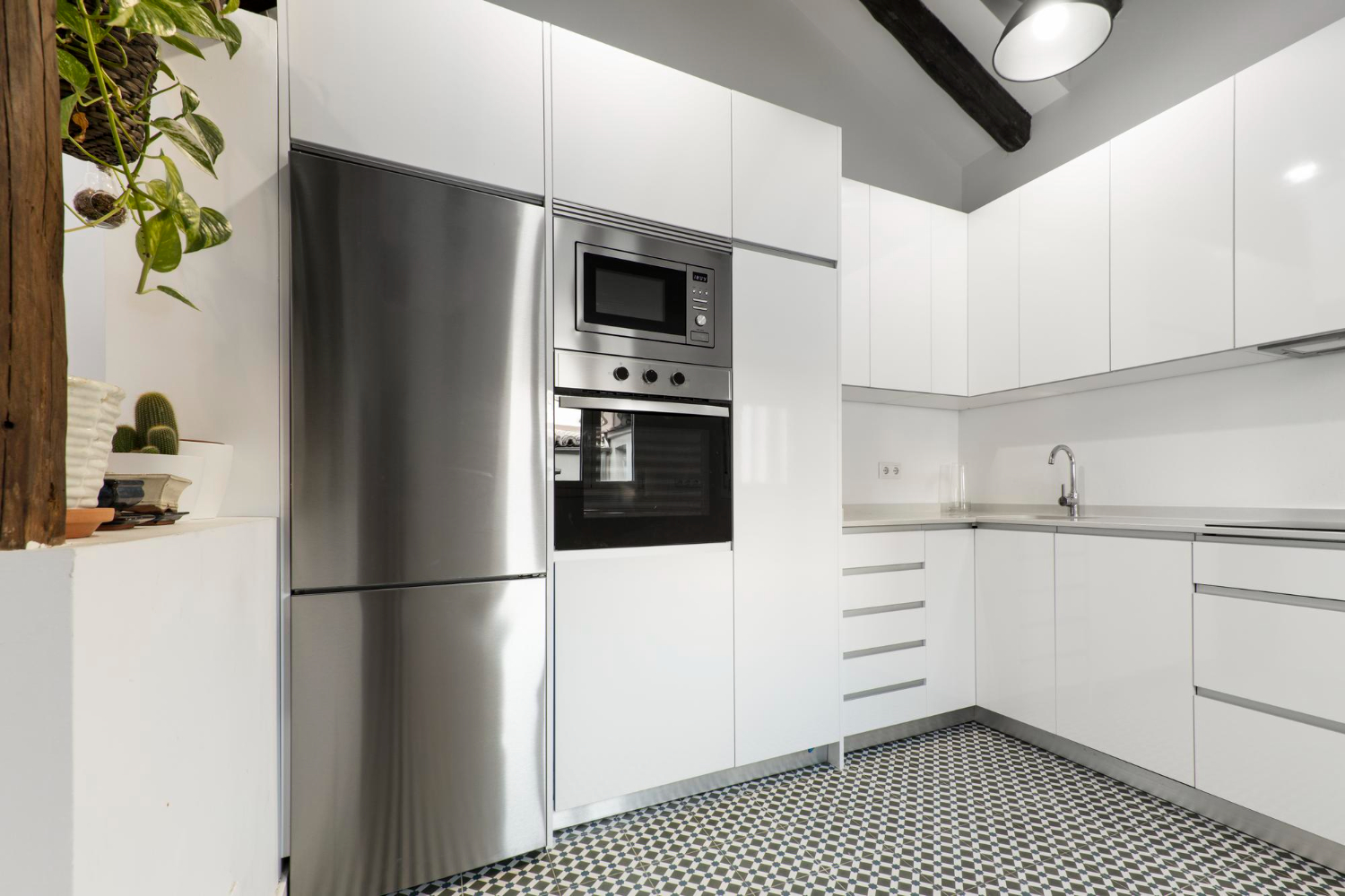 Modern kitchen with stainless steel refrigerator and built in oven