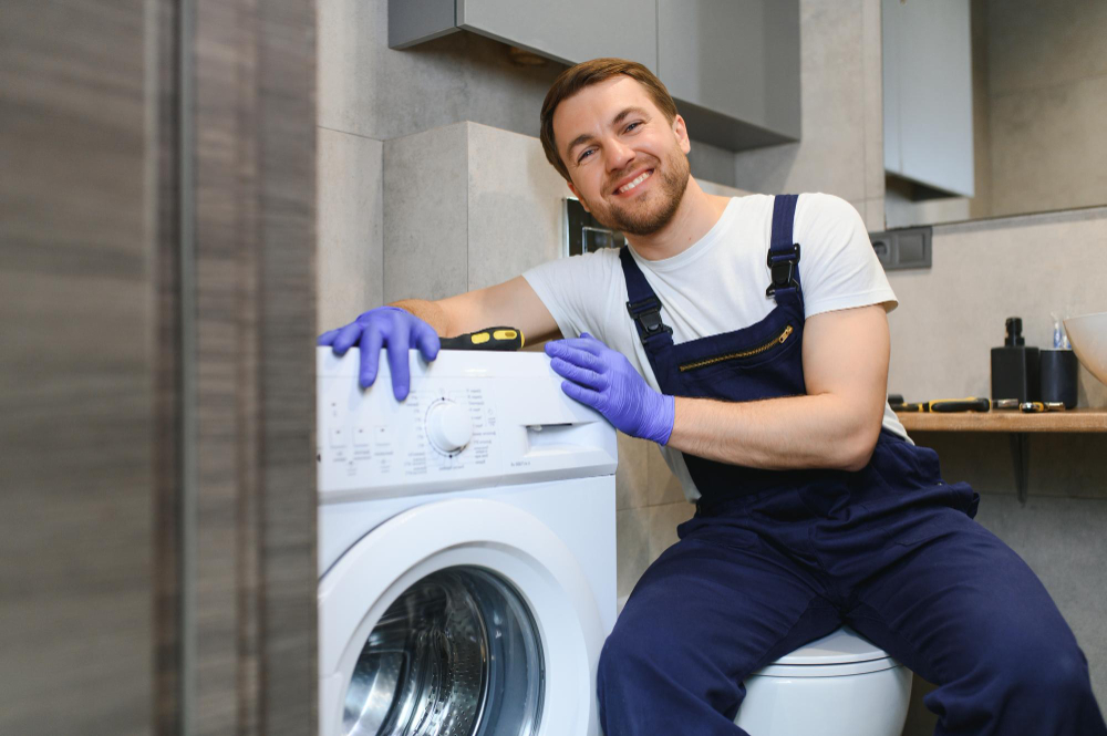 Appliance repair technician servicing a washing machine in Fontana CA