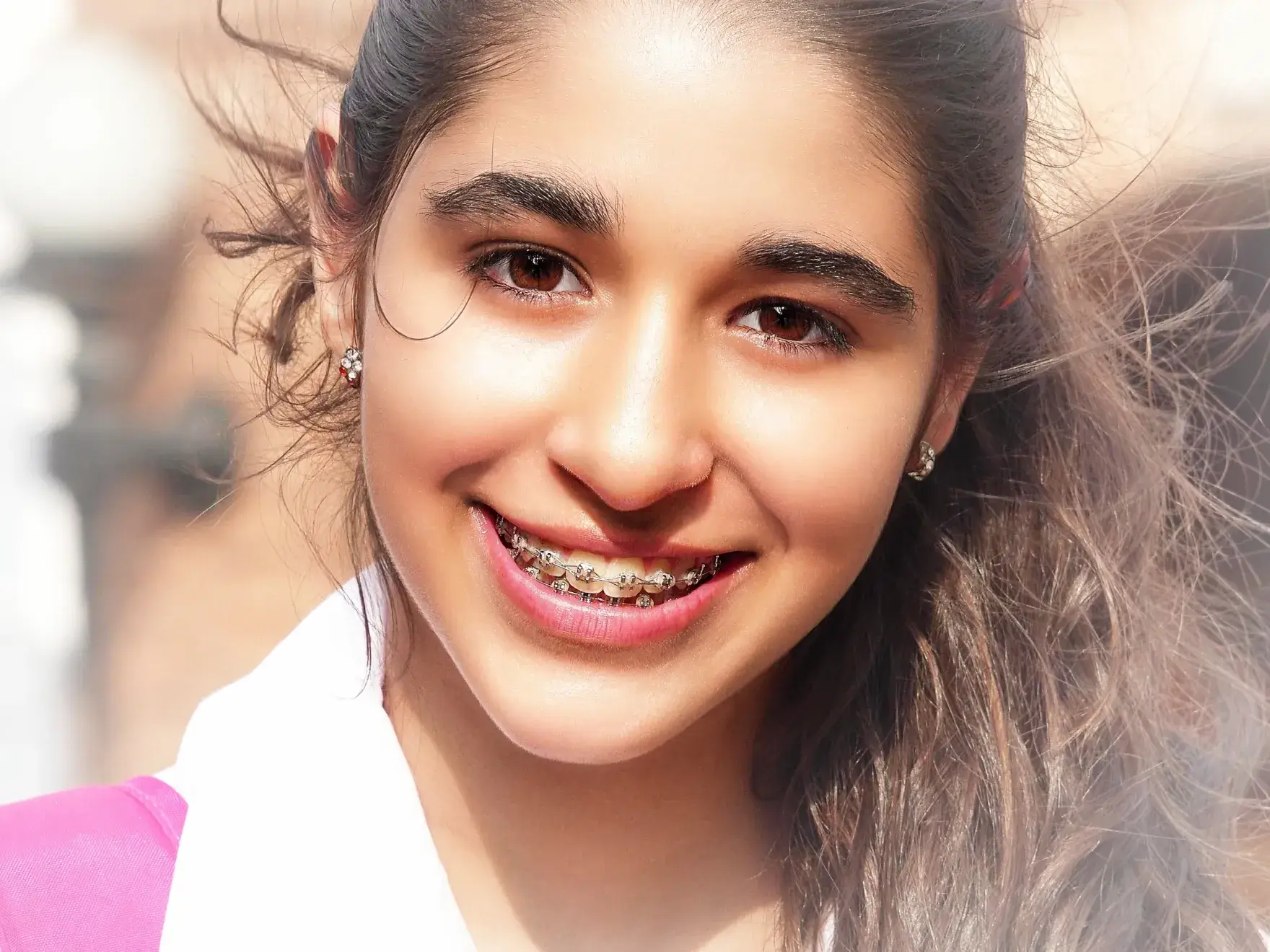 Woman with aligners smiling and posing to the camara