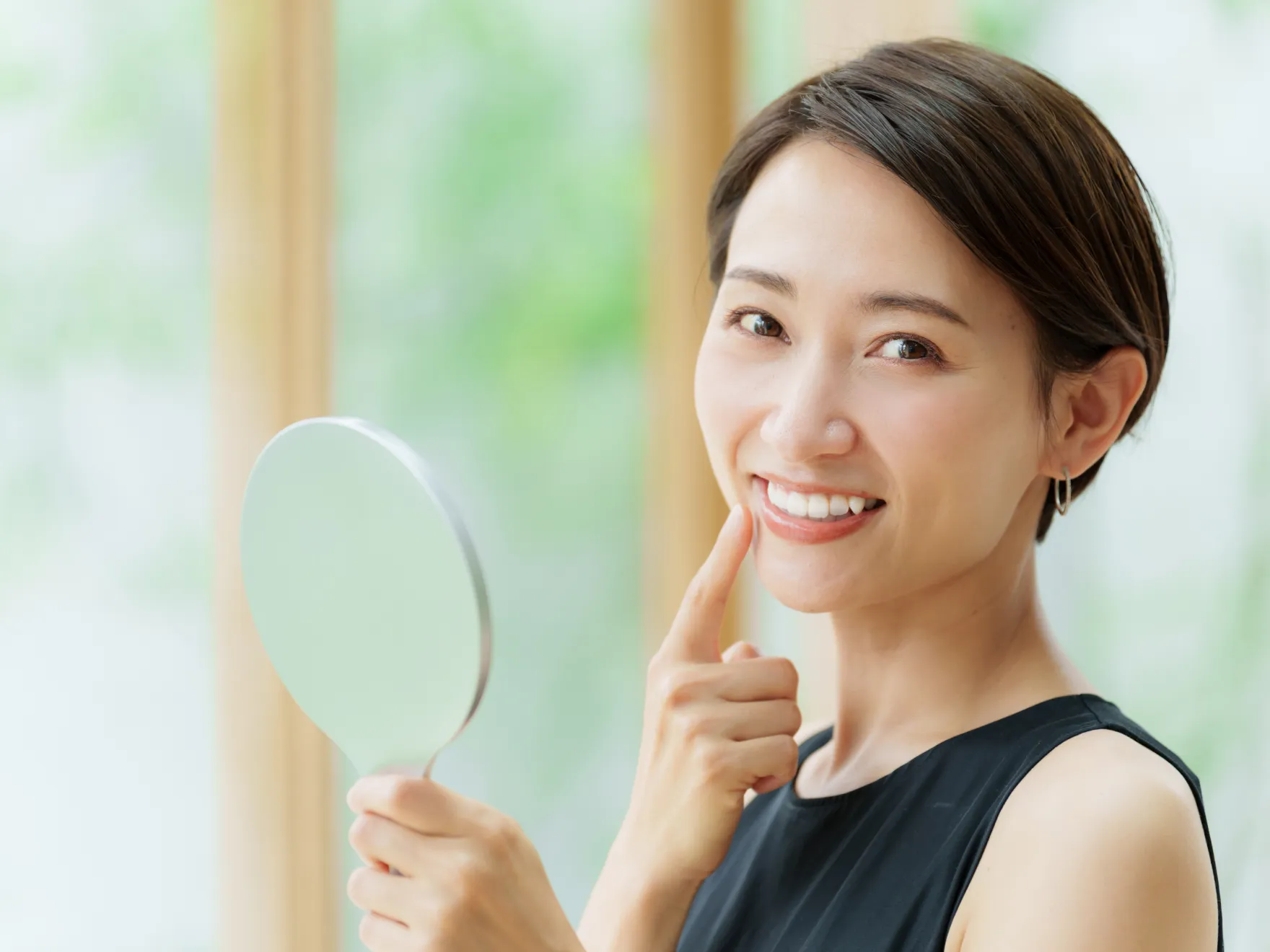 woman checking her smile in the mirror