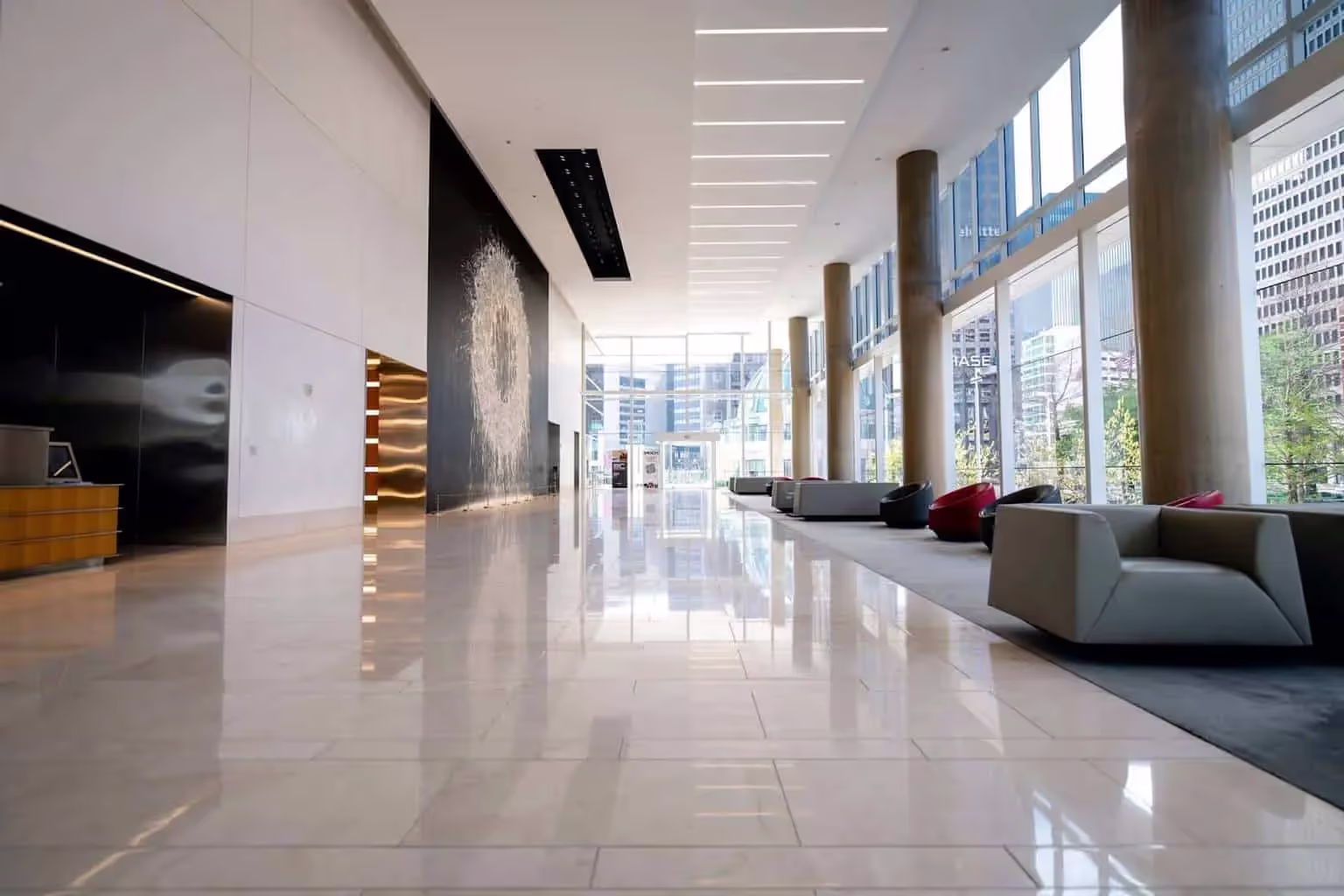 Luxury hotel lobby with white tile floor and floor-to-ceiling windows