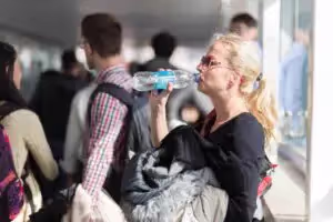 Woman drinking bottled water in airport