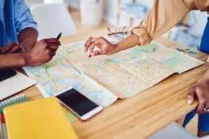 Two people looking at map on desk