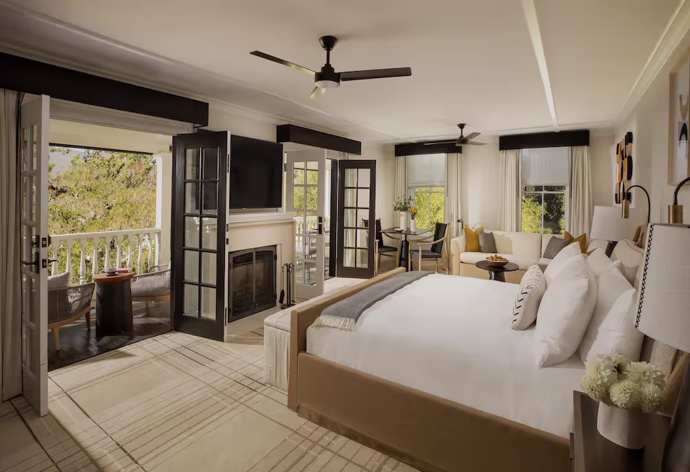 A bedroom with a fireplace and a bedDescription automatically generated