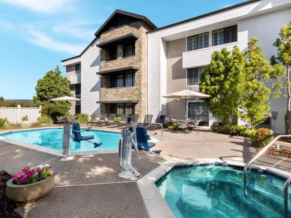 A swimming pool and a buildingDescription automatically generated