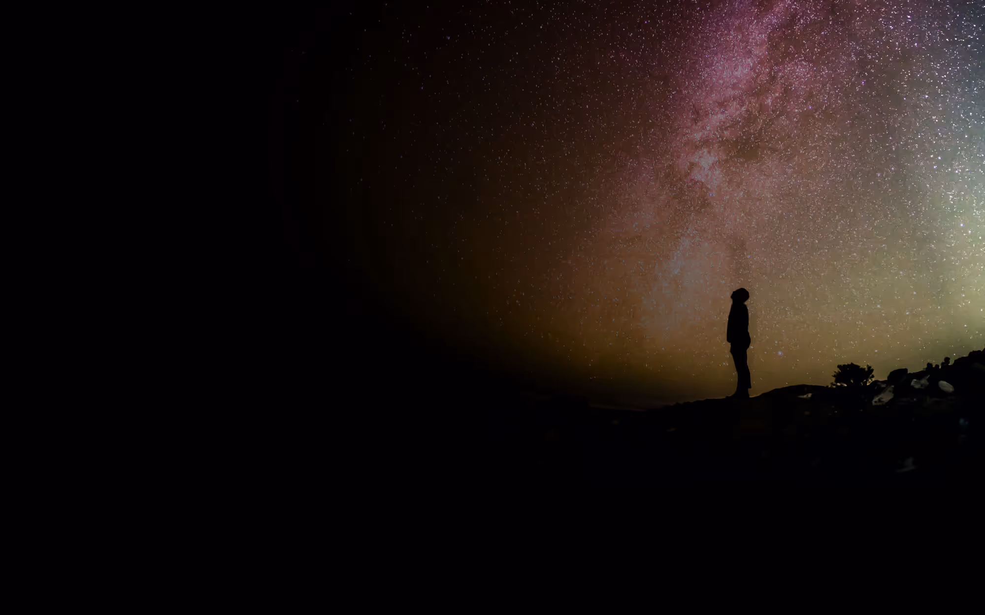 A sky with stars and a man looking up